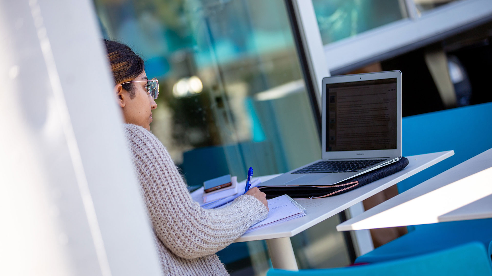 Woman reading information on laptop screen